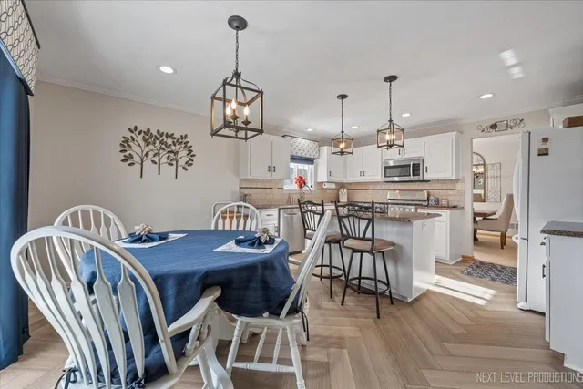 a view of a dining room with furniture kitchen and wooden floor