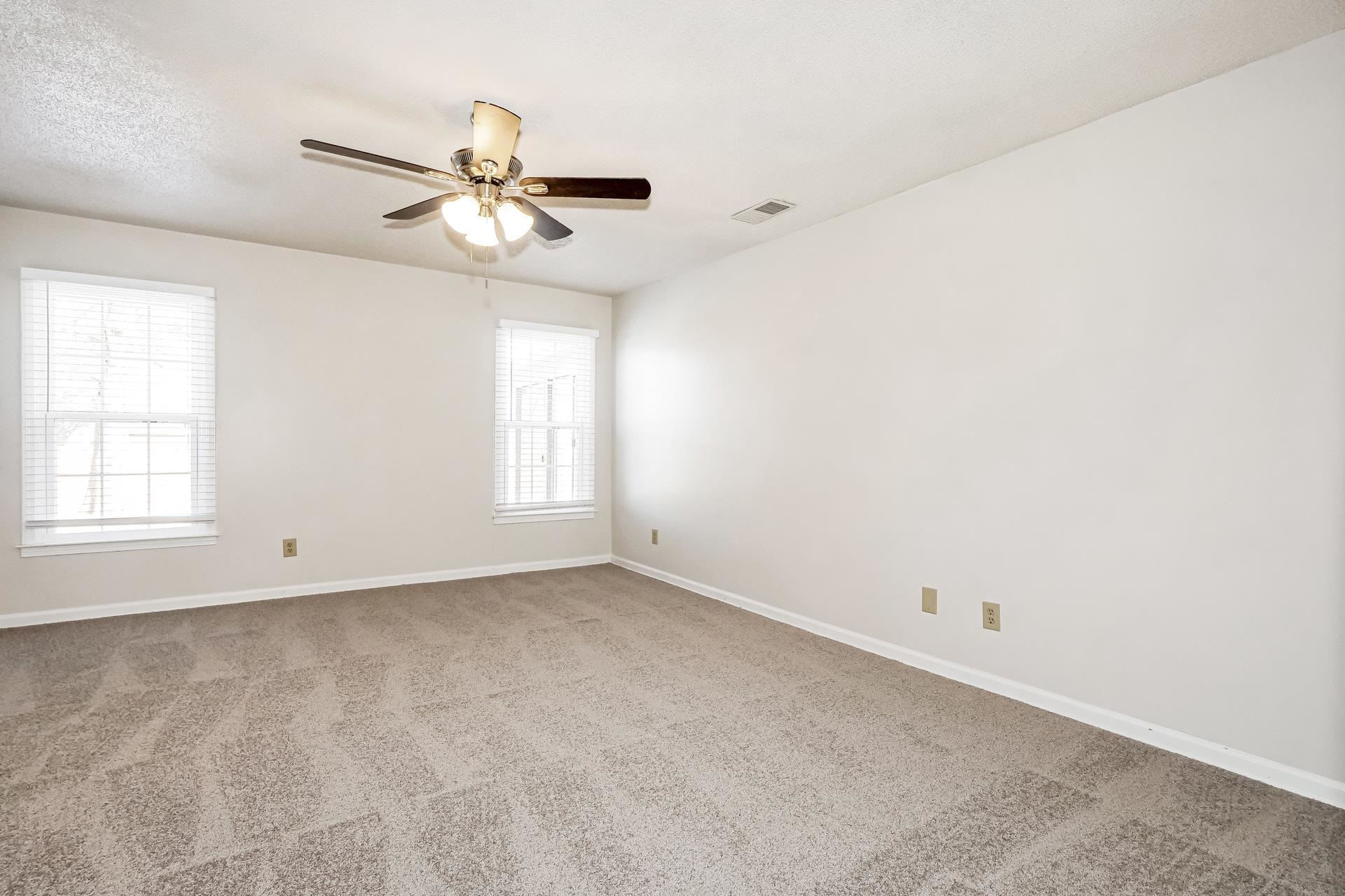 4290 Timber Jump Cove Memphis, TN 38141 - Photo 2 of 17 an empty room with windows and fan