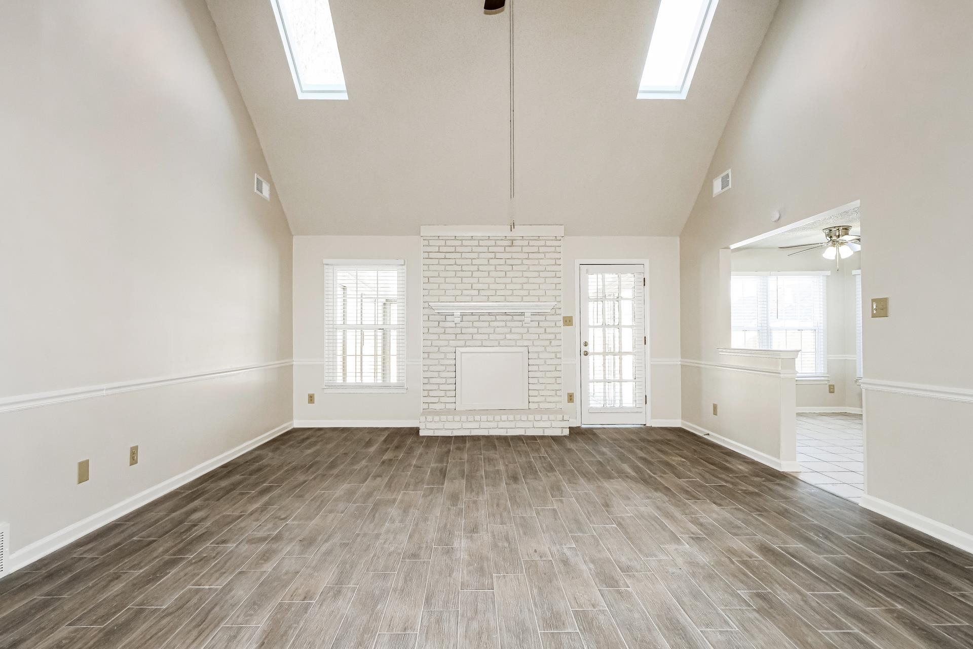 4290 Timber Jump Cove Memphis, TN 38141 - Photo 5 of 17 an empty room with wooden floor and windows