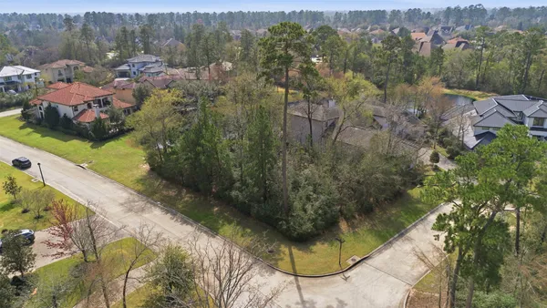 an aerial view of residential houses with outdoor space and lake view