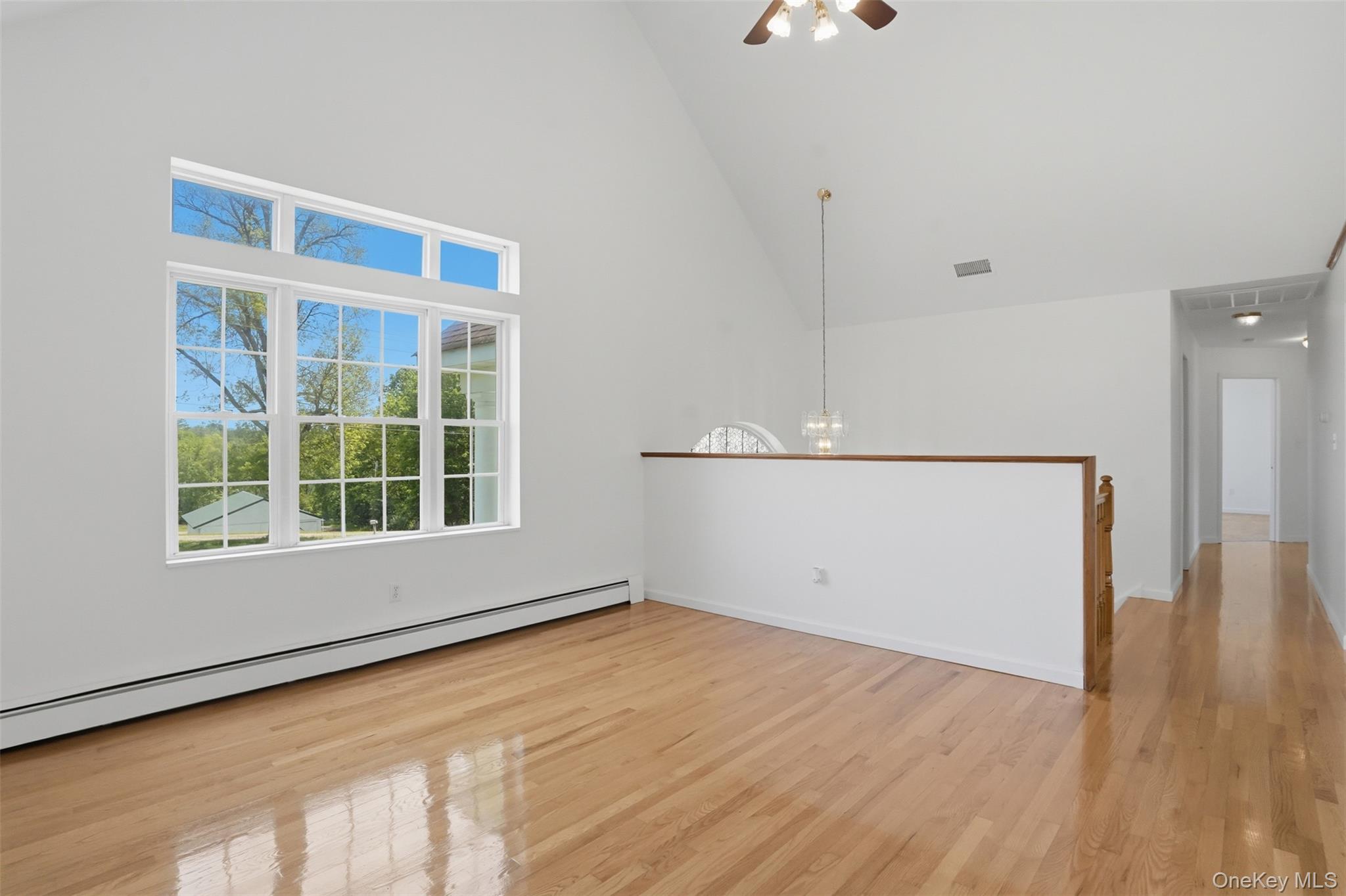 160 Pirog Road Pine Bush, NY 12566 - Photo 9 of 50 an empty room with wooden floor and windows