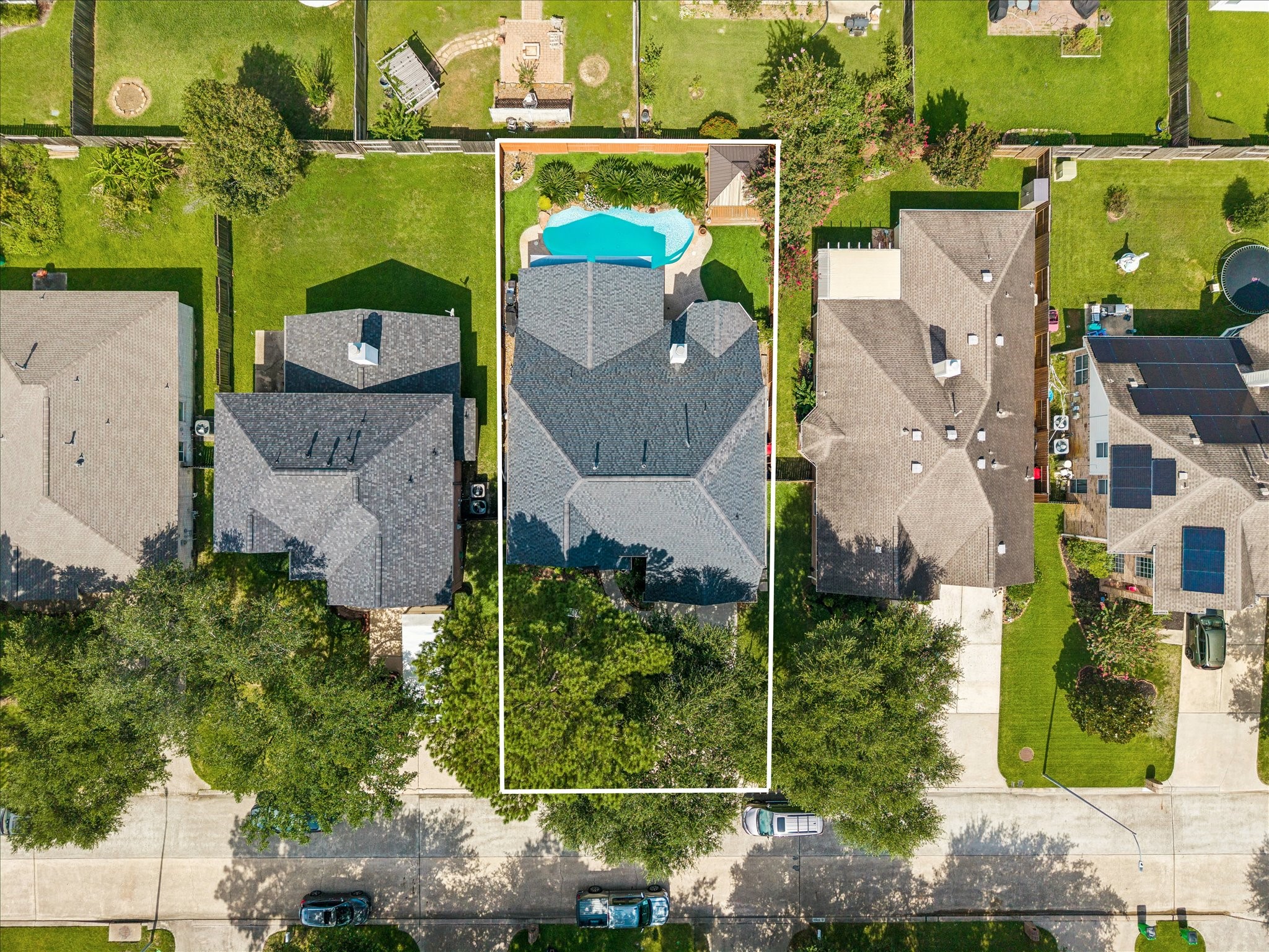 20923 Wind Field Lane Spring, TX 77379 - Photo 3 of 29 Spacious home with a stunning backyard featuring a pool, surrounded by lush greenery, perfect for outdoor relaxation and entertainment.