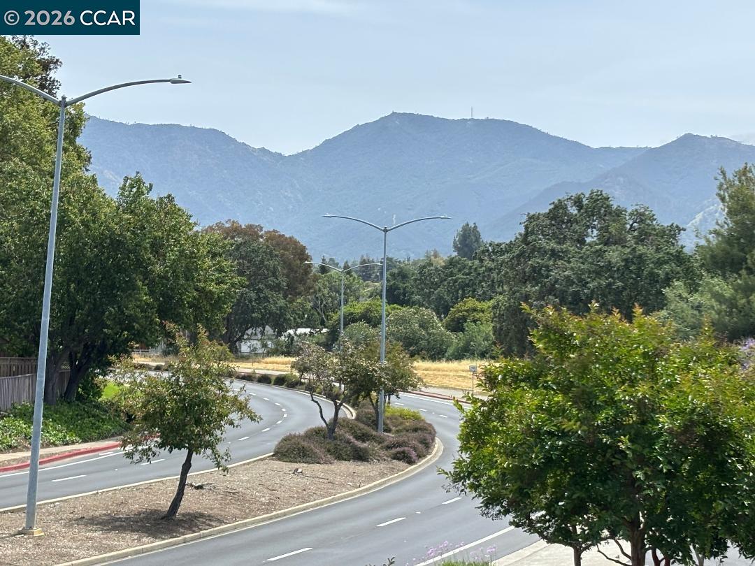 5460 Concord Boulevard, Unit B7 Concord, CA 94521 - Photo 1 of 20 a view of a house with a mountain in the background