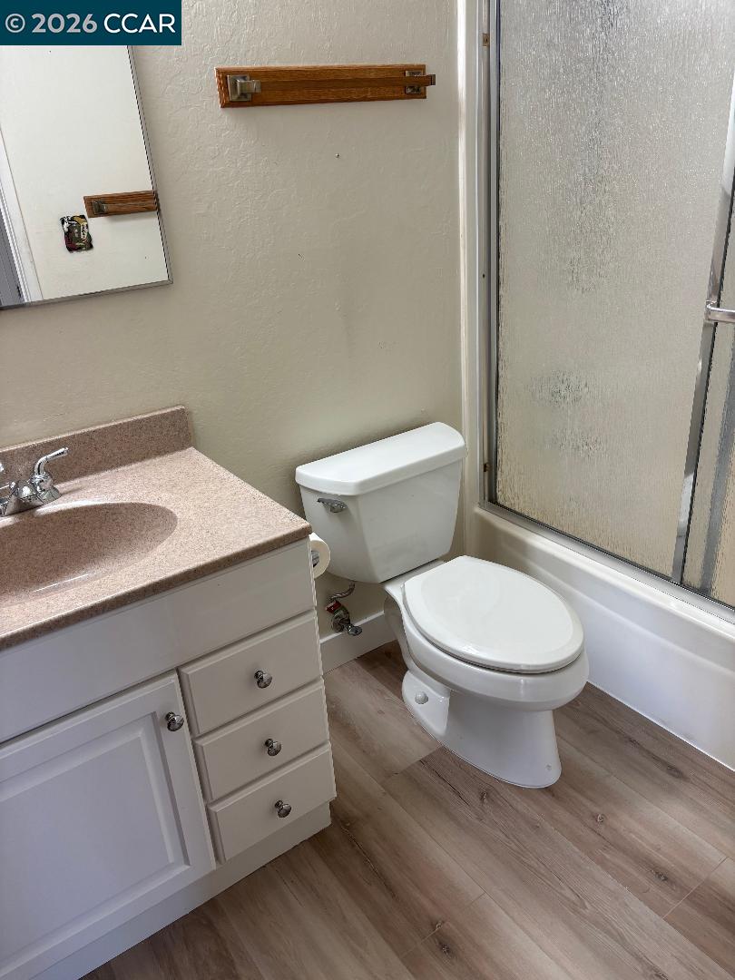 5460 Concord Boulevard, Unit B7 Concord, CA 94521 - Photo 13 of 20 a bathroom with a toilet a sink and mirror