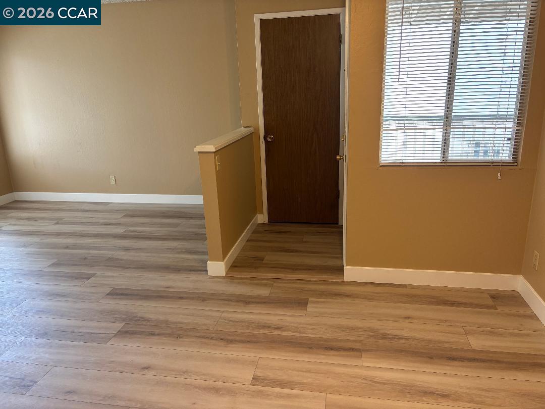 5460 Concord Boulevard, Unit B7 Concord, CA 94521 - Photo 5 of 20 a view of wooden floor and windows in a room
