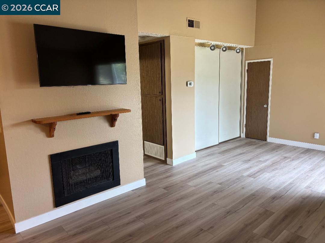 5460 Concord Boulevard, Unit B7 Concord, CA 94521 - Photo 8 of 20 a view of a livingroom with an empty space and a fireplace