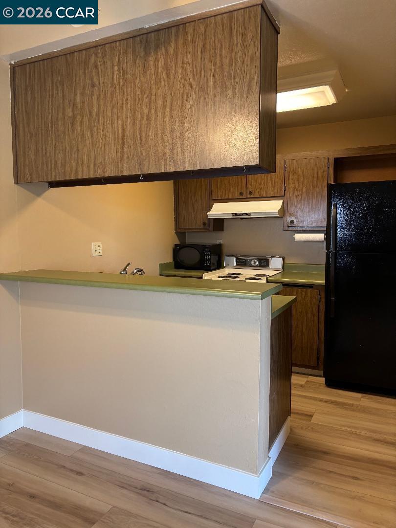 5460 Concord Boulevard, Unit B7 Concord, CA 94521 - Photo 10 of 20 a kitchen with a refrigerator and a stove