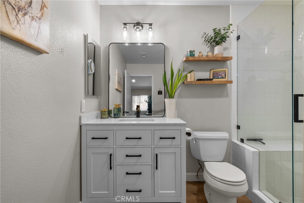 28818 Oak Springs Canyon Road Canyon Country, CA 91387 - Photo 15 of 38 a bathroom with a toilet a sink and a mirror