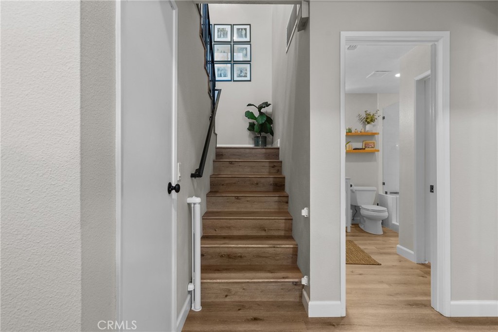 28818 Oak Springs Canyon Road Canyon Country, CA 91387 - Photo 17 of 38 a view of a hallway with wooden floor and staircase