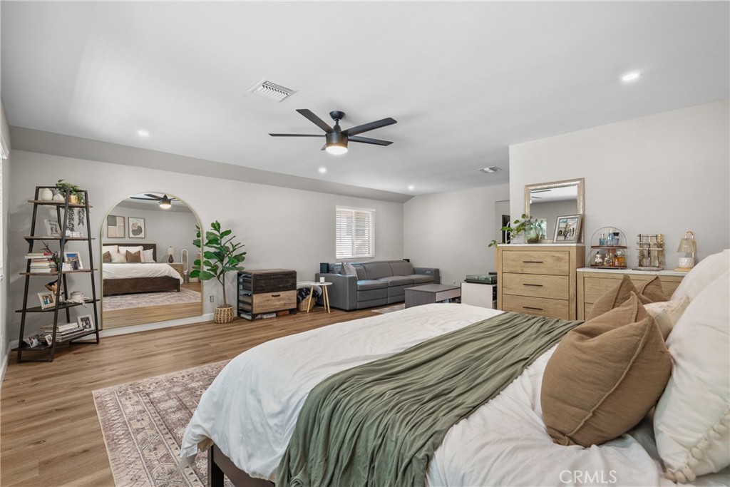 28818 Oak Springs Canyon Road Canyon Country, CA 91387 - Photo 25 of 38 a spacious bedroom with a bed a window and a potted plant on the dresser