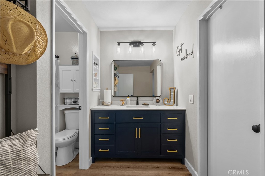 28818 Oak Springs Canyon Road Canyon Country, CA 91387 - Photo 26 of 38 a bathroom with a granite countertop sink a toilet and a mirror