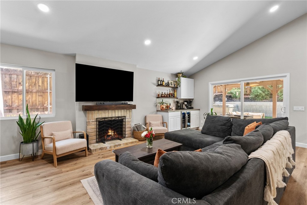 28818 Oak Springs Canyon Road Canyon Country, CA 91387 - Photo 4 of 38 a living room with furniture a flat screen tv and a fireplace