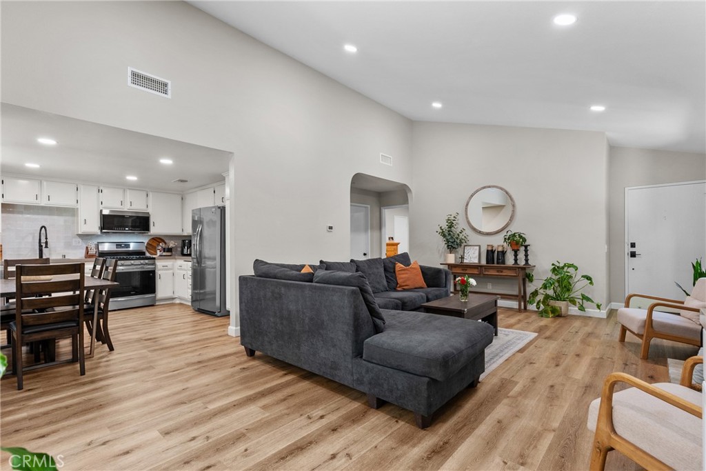 28818 Oak Springs Canyon Road Canyon Country, CA 91387 - Photo 7 of 38 a living room with furniture kitchen view and a wooden floor
