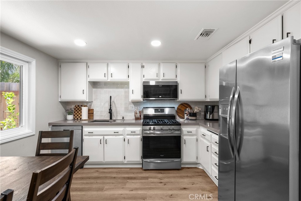 28818 Oak Springs Canyon Road Canyon Country, CA 91387 - Photo 10 of 38 a kitchen with stainless steel appliances granite countertop a stove a sink dishwasher a refrigerator and a microwave