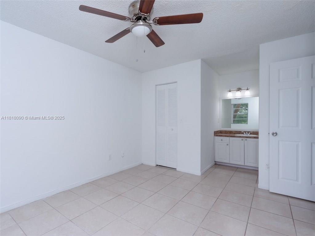 1235 Southwest 46th Avenue, Unit 707 Pompano Beach, FL 33069 - Photo 11 of 15 a view of a kitchen with a sink and cabinet