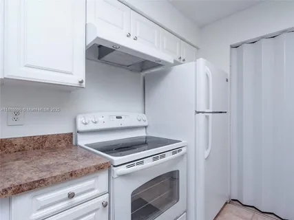 a kitchen with appliances cabinets and a counter top space