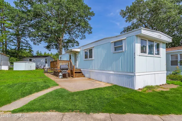 a view of backyard with house and sitting area