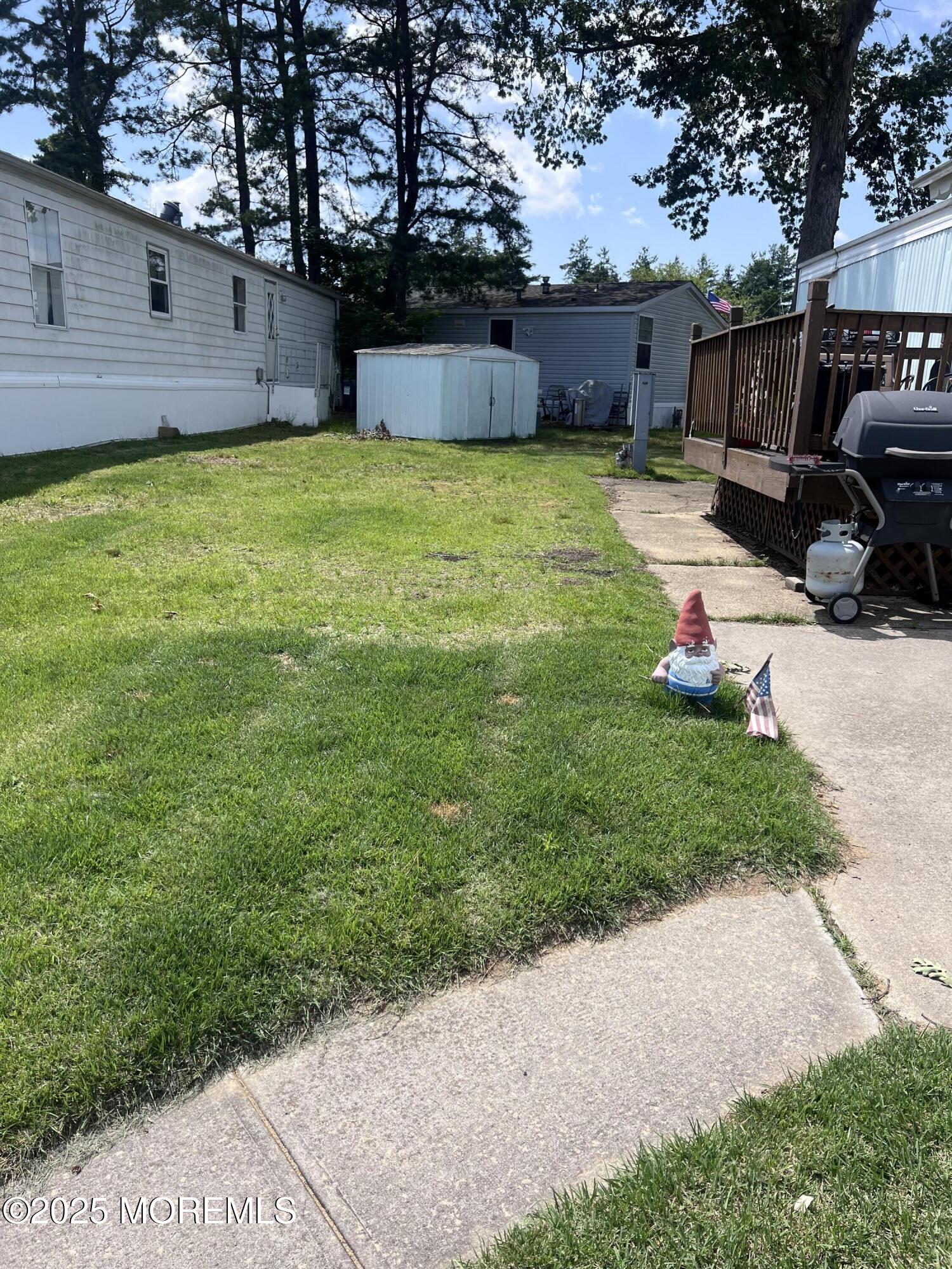 819 North Street Jackson, NJ 08527 - Photo 5 of 16 a backyard of a house with a garden and barbeque oven