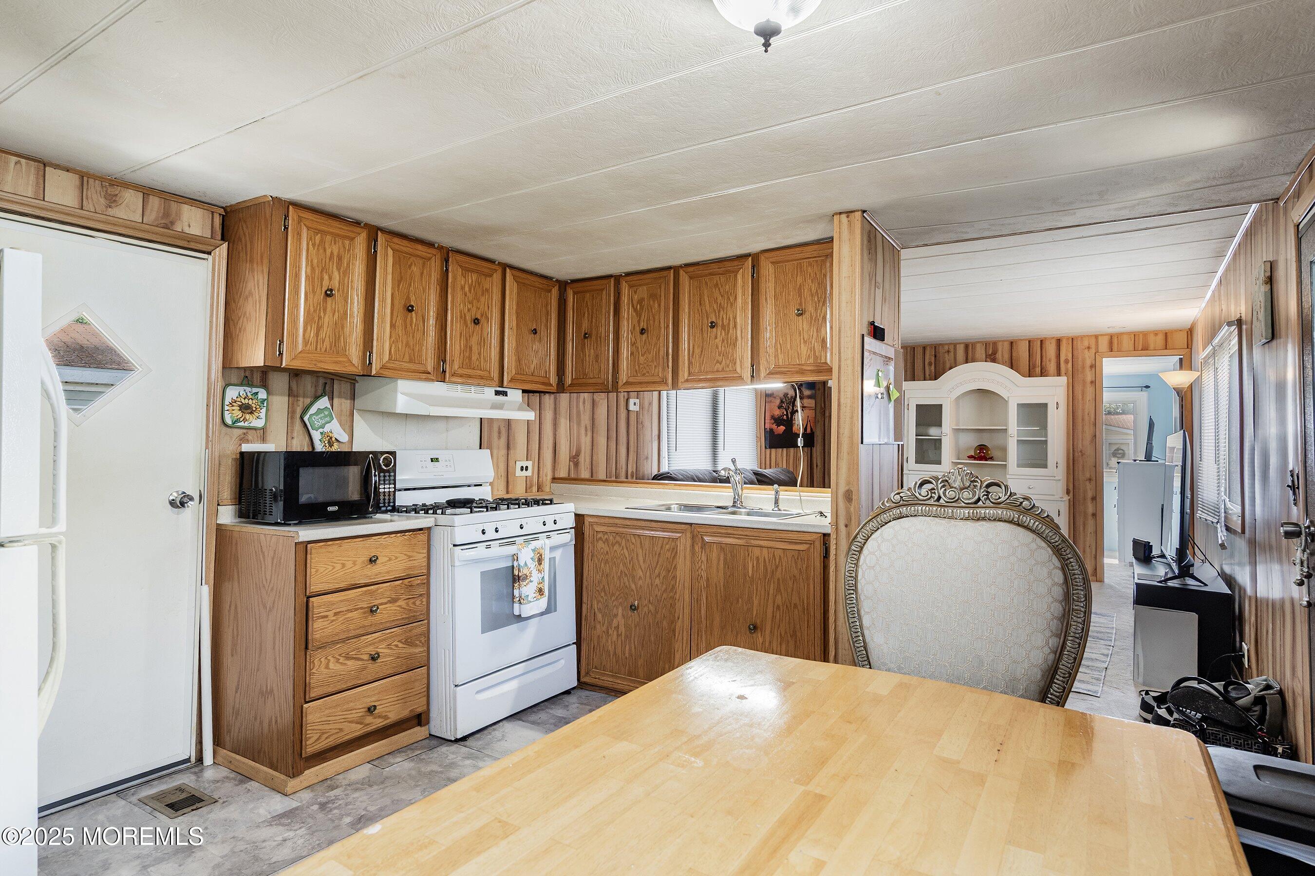 819 North Street Jackson, NJ 08527 - Photo 6 of 16 a kitchen with a stove a sink and a refrigerator
