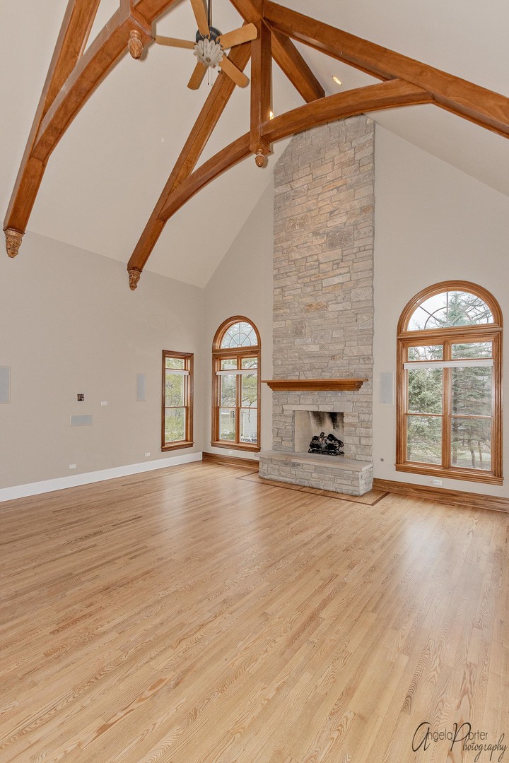 3513 Deep Wood Drive Crystal Lake, IL 60012 - Photo 15 of 71 a view of an empty room with a fireplace and wooden floor