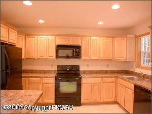 1408 Ridge Road Pocono Lake, PA 18347 - Photo 3 of 5 a kitchen with stainless steel appliances granite countertop a stove a sink and a refrigerator