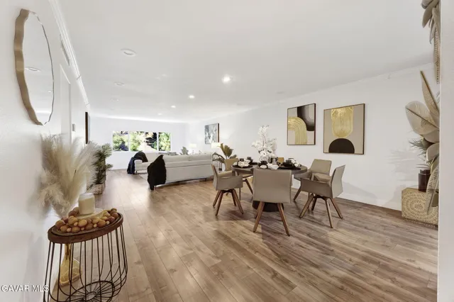 a living room with furniture a table and wooden floor
