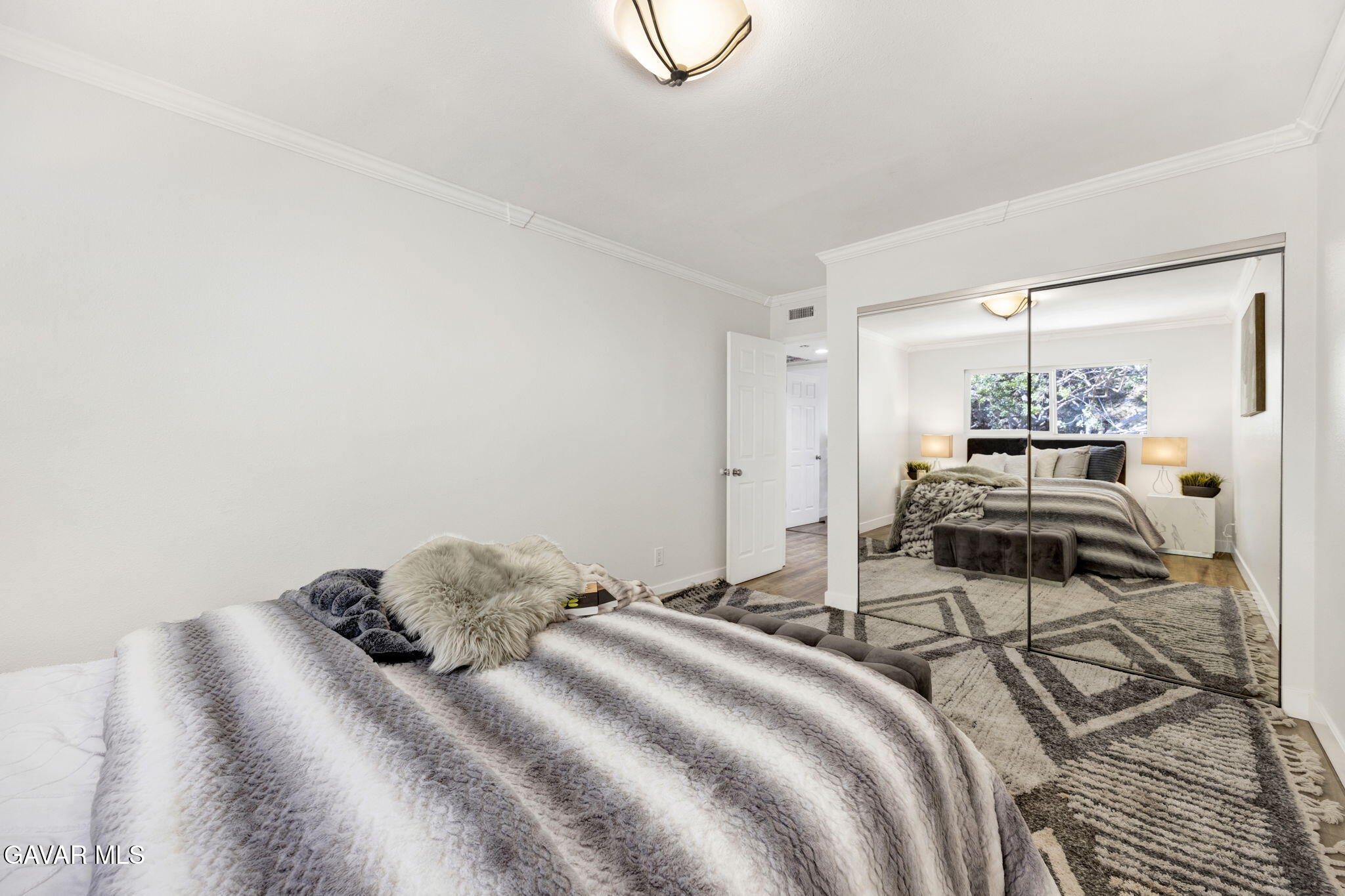 1935 Alpha Road, Unit 112 Glendale, CA 91208 - Photo 17 of 23 a bedroom with a bed and a chandelier