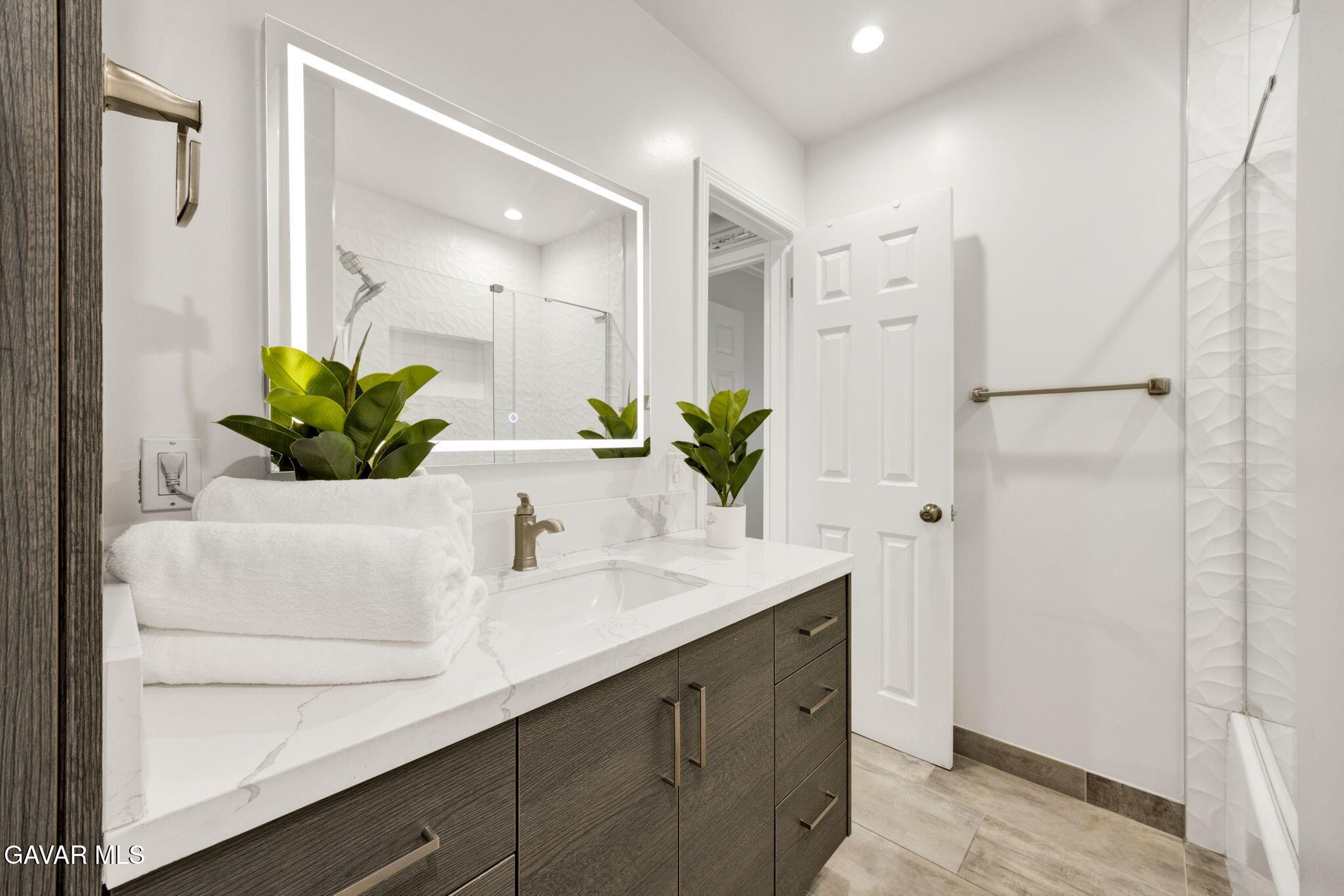 1935 Alpha Road, Unit 112 Glendale, CA 91208 - Photo 19 of 23 a bathroom with a double vanity sink and mirror