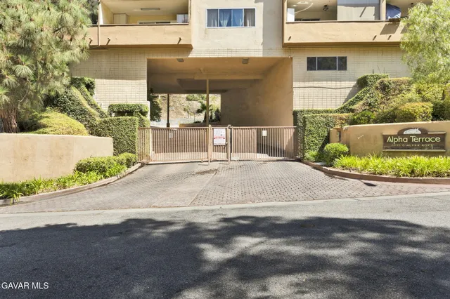 a white house with a yard and plants