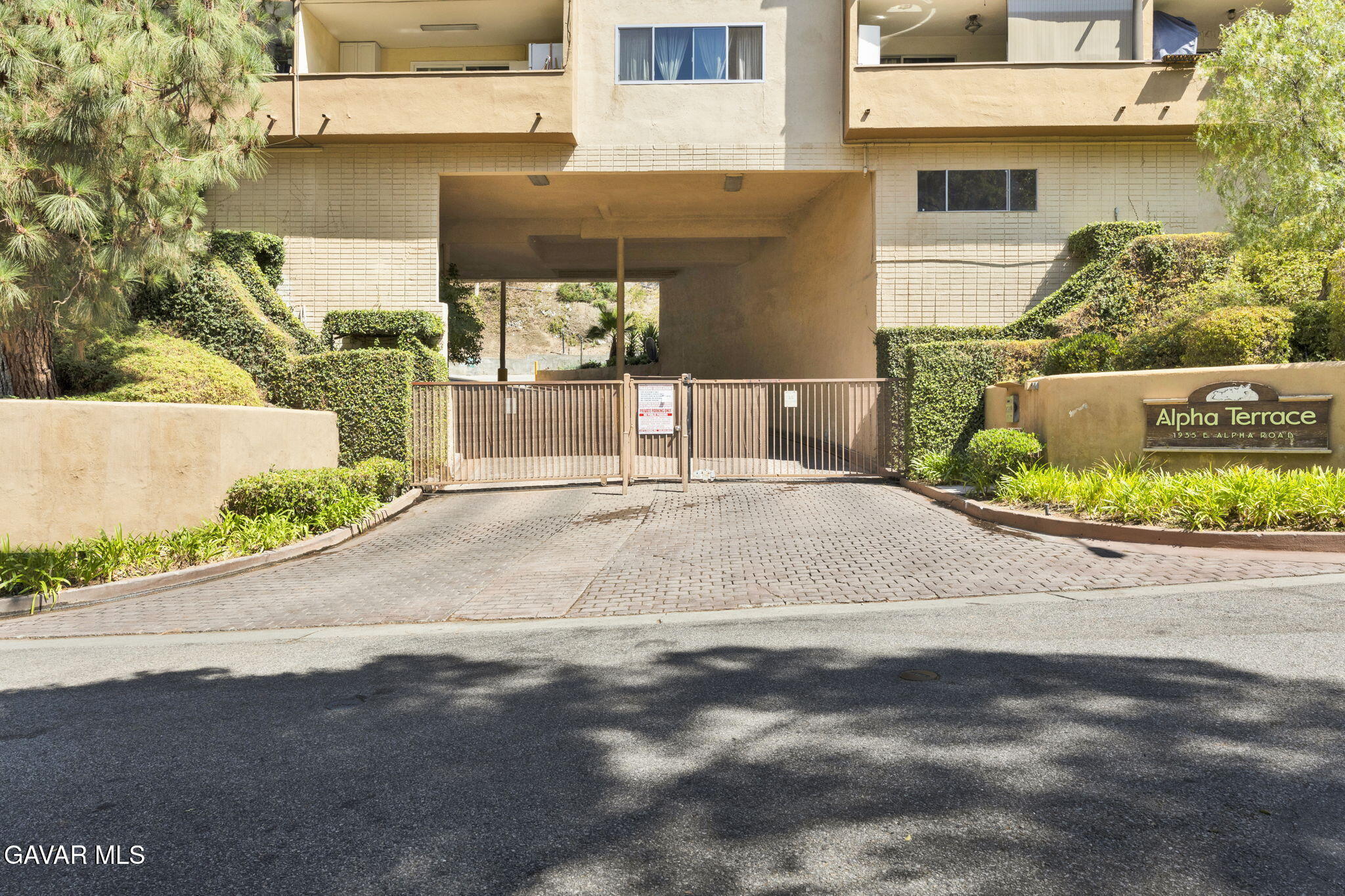 1935 Alpha Road, Unit 112 Glendale, CA 91208 - Photo 20 of 23 a white house with a yard and plants