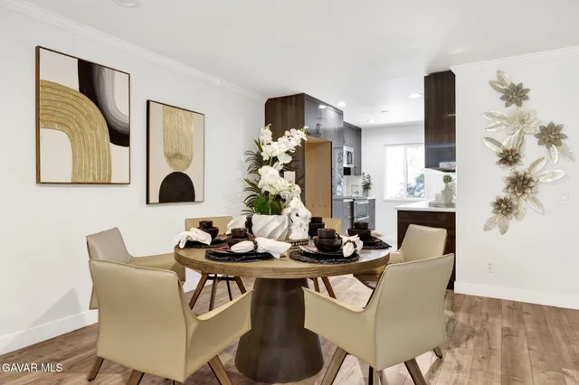 a dining room with furniture and wooden floor