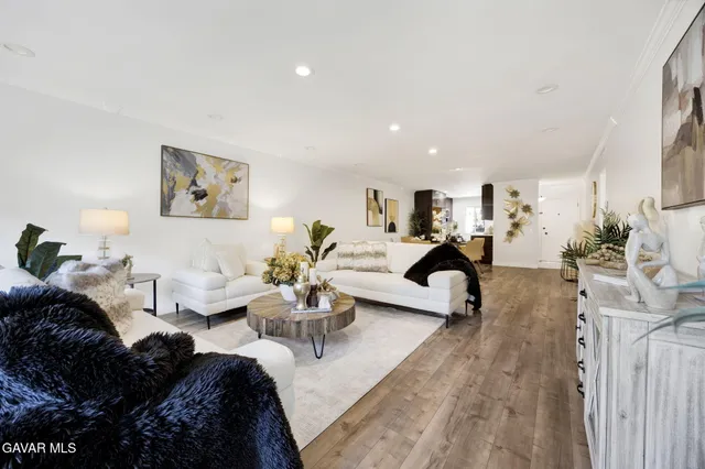 a living room with furniture large mirror and furniture