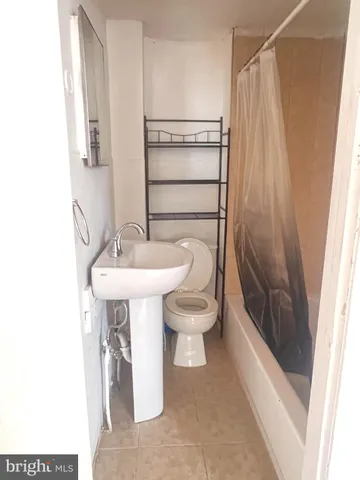 a view of a street with cars parked on road