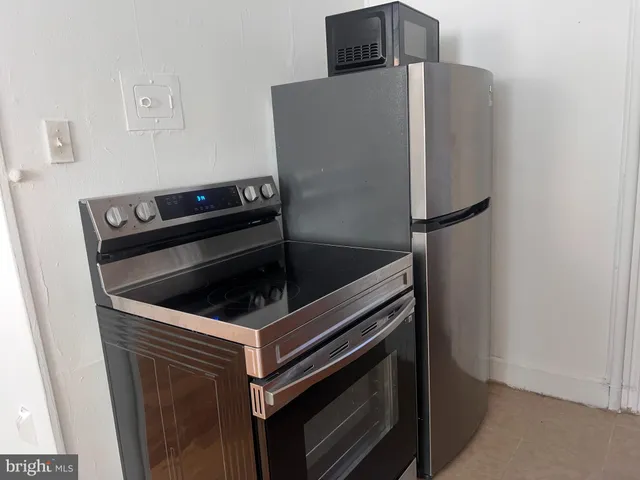 a kitchen with granite countertop white cabinets and a sink