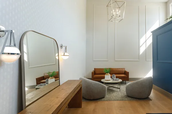 a living room with furniture wooden floor and a chandelier