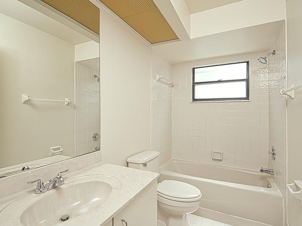 5270 Southeast Seascape Way, Unit 103 Stuart, FL 34997 - Photo 13 of 21 a bathroom with a sink toilet and shower