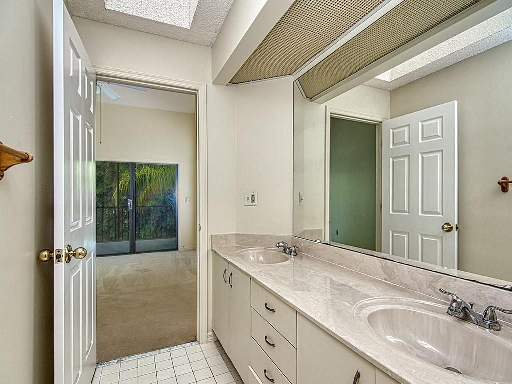 5270 Southeast Seascape Way, Unit 103 Stuart, FL 34997 - Photo 17 of 21 a bathroom with a granite countertop sink mirror and double