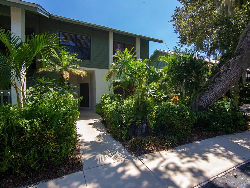 5270 Southeast Seascape Way, Unit 103 Stuart, FL 34997 - Photo 3 of 21 a front view of a house with a yard