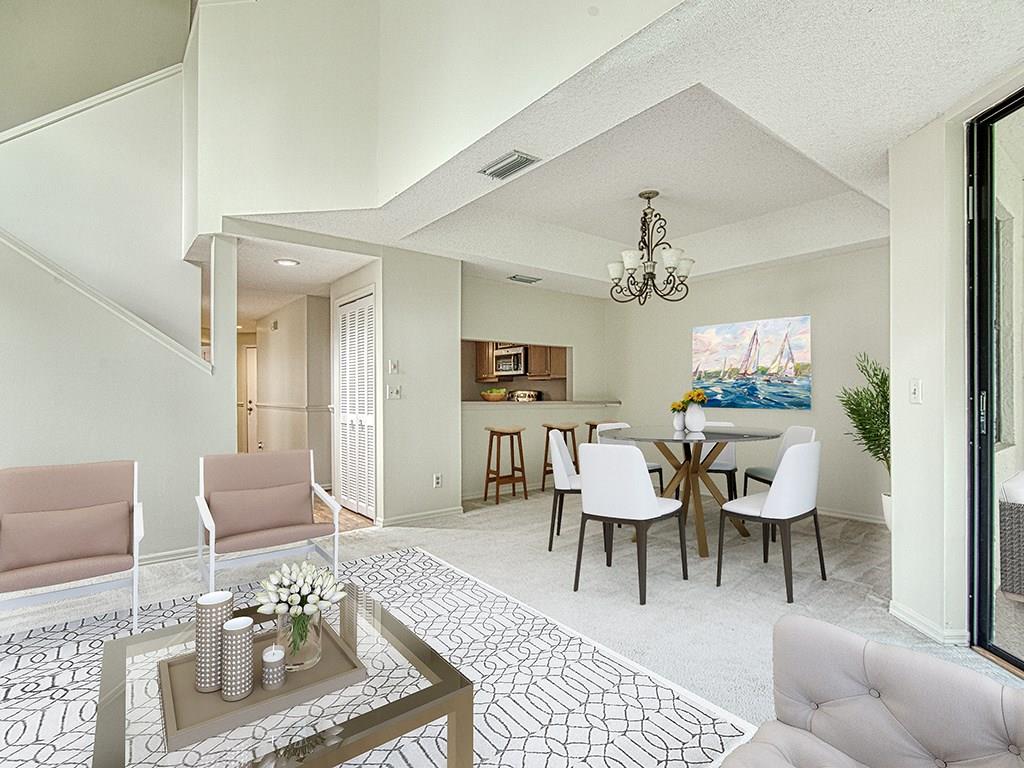 5270 Southeast Seascape Way, Unit 103 Stuart, FL 34997 - Photo 7 of 21 a dining room with furniture a rug and wooden floor