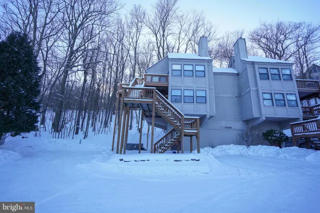 a view of a house with a park bench