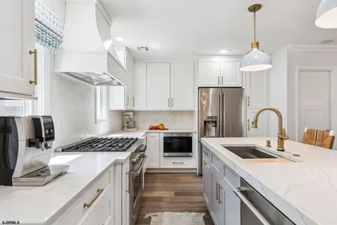 a kitchen with a sink stove and refrigerator