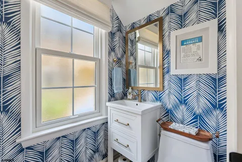 a bathroom with a sink a mirror and a window