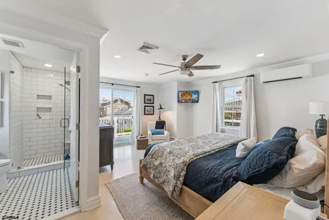 a bedroom with a large bed and a chandelier