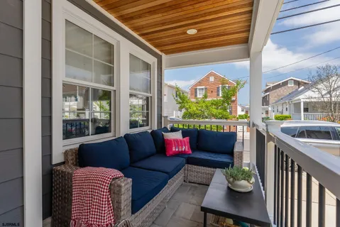 a view of a patio with couches table and chairs and potted plants