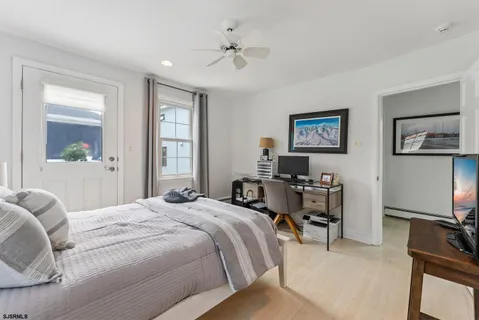 a bedroom with a bed furniture and a flat screen tv