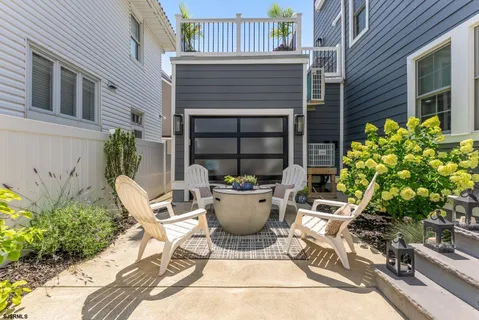 a view of a patio with table and chairs potted plants