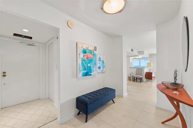 a living room with furniture and a air conditioner vent