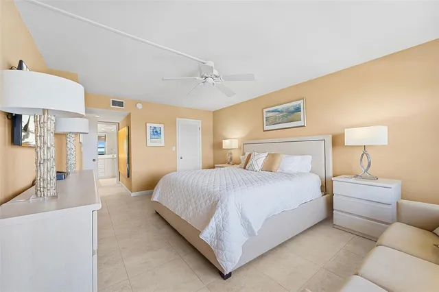 a bedroom with a bed and lamp