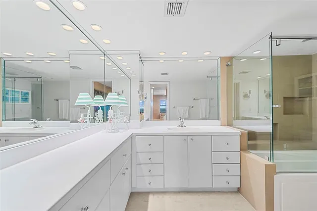 a spacious bathroom with a shower sink and mirror