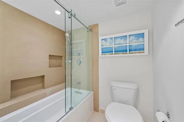 a bathroom with a toilet and a bathtub